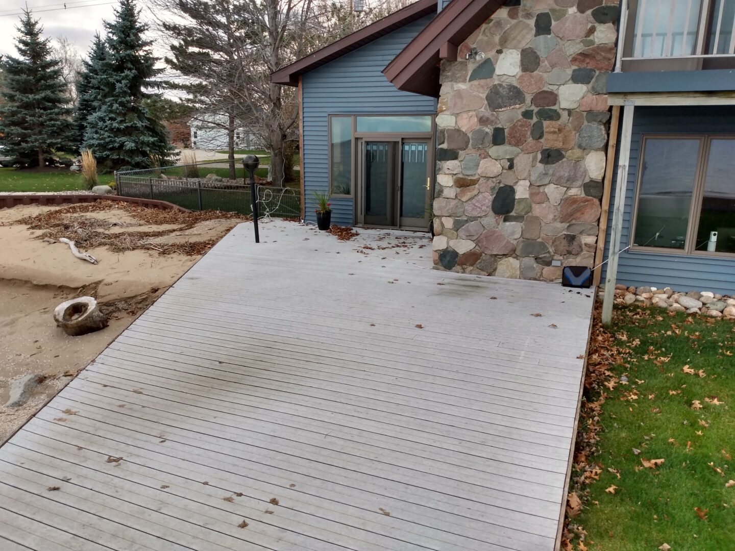 Before image of a worn deck on a beach.